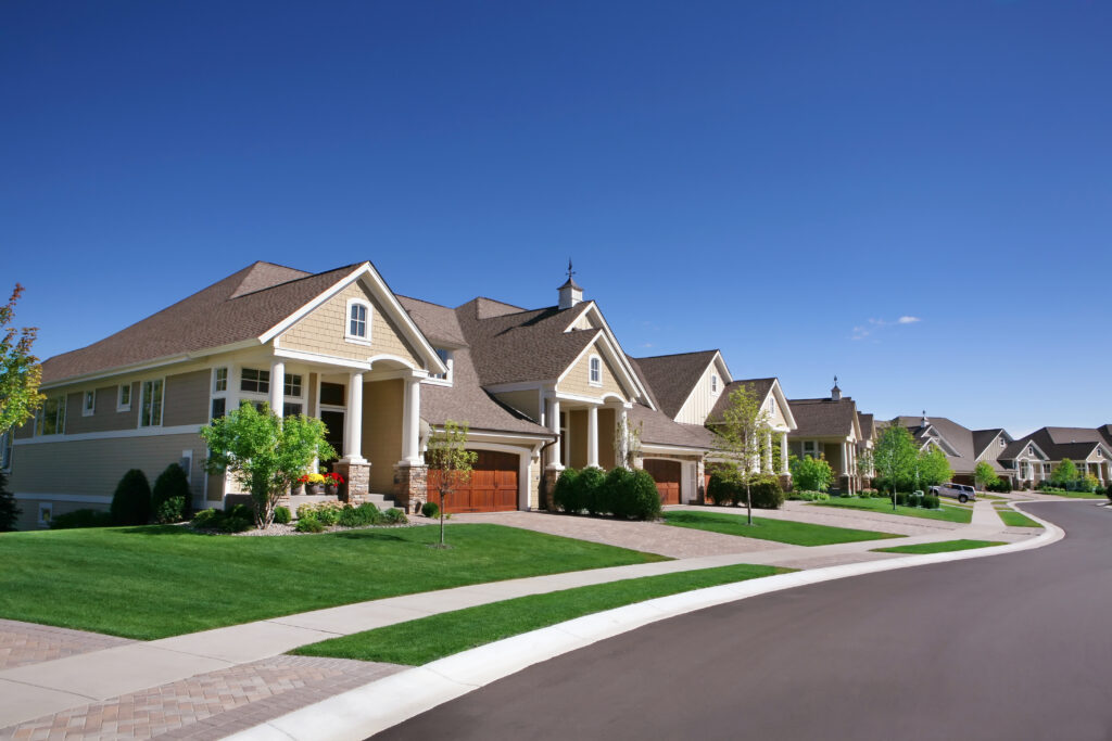 Investing In Real Estate: 7 Reasons To Start Now 1 Suburban neighborhood with nicely manicured lawns.