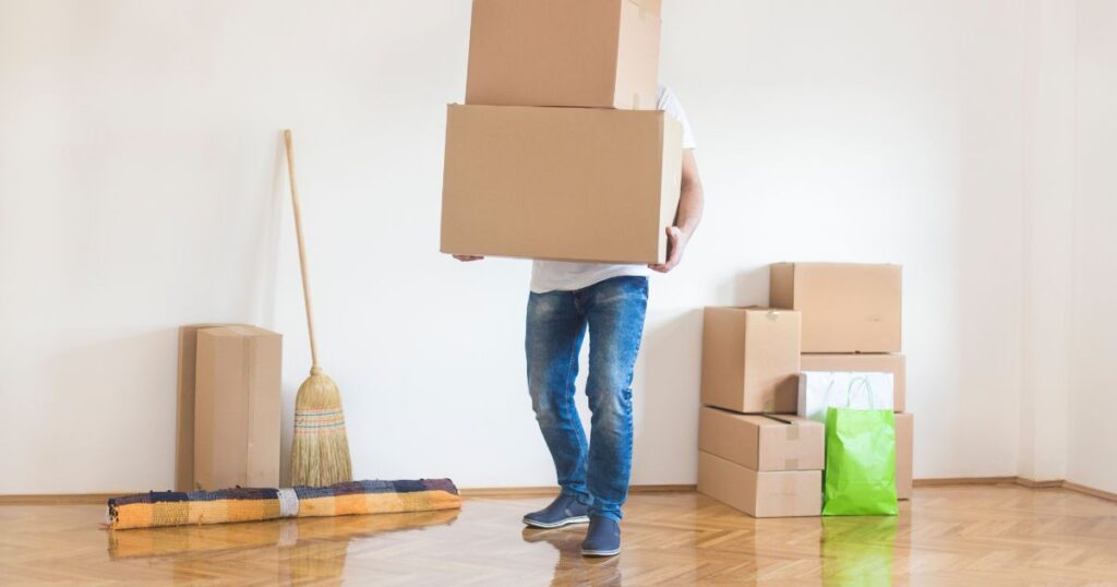 Man carrying boxes during a move.
