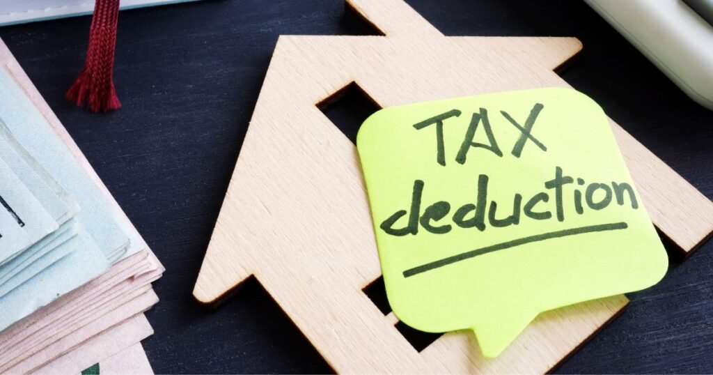 Investing In Real Estate: 7 Reasons To Start Now 2 Tax deduction memo stuck to a wooden house cut out, investing in real estate